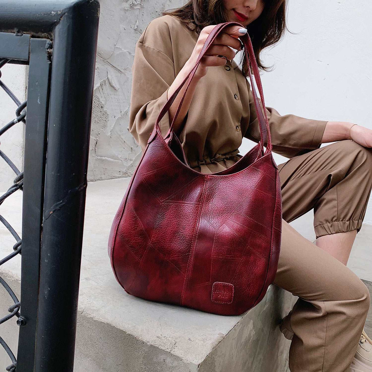 Vegan Leather Tote Bag in burgundy textured material with double shoulder straps and a soft-sided shape